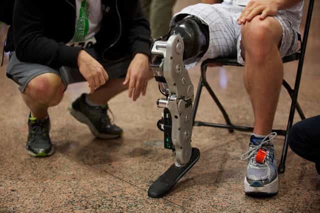 Zac Vawter, a 31-year-old software engineer from Seattle, Washington, prepares to climb to the 103rd story of the Willis Tower using the world's first neural-controlled Bionic leg in Chicago, on November 4, 2012. According to the Rehabilitation Institute of Chicago, their Center for Bionic Medicine has worked to develop technology that allows amputees like Vawter to better control prosthetics with their own thoughts. (Photo by John Gress/Reuters)
