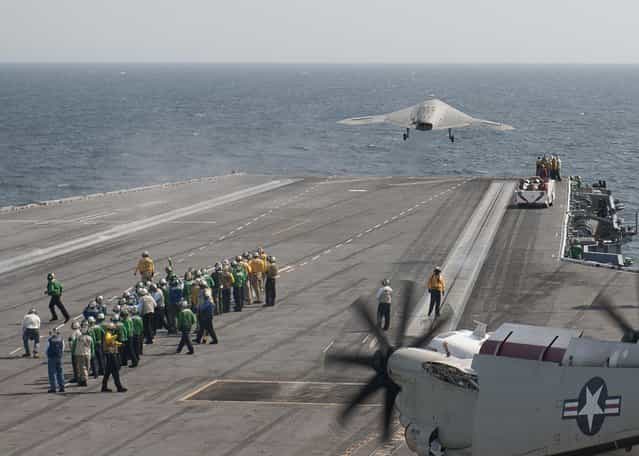 An X-47B Unmanned Combat Air System (UCAS) demonstrator launches from the aircraft carrier USS George H.W. Bush (CVN 77) after completing its first arrested landing on the flight deck of an aircraft carrier. The landing marks the first time any unmanned aircraft has completed an arrested landing at sea. George H.W. Bush is conducting training operations in the Atlantic Ocean. (Photo by Mass Communication Specialist 3nd Class Christopher A. Liaghat/U.S. Navy)