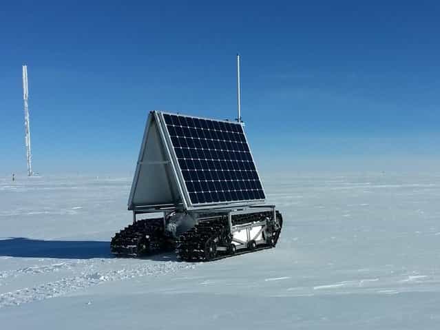 NASA's new Earth-bound rover, GROVER, which stands for both Greenland Rover and Goddard Remotely Operated Vehicle for Exploration and Research, in Summit Camp, the highest spot in Greenland, on May 10, 2013. GROVER is an autonomous, solar-operated robot that carries a ground-penetrating radar to examine the layers of Greenland's ice sheet. Its findings will help scientists understand how the massive ice sheet gains and loses ice. After loading and testing the rover's radar and fixing a minor communications glitch, the team began the robot's tests on the ice on May 8, defying winds of up to 23 mph (37 kph) and temperatures as low as minus 22 F (minus 30 C). (Photo by Lora Koenig/NASA Goddard)