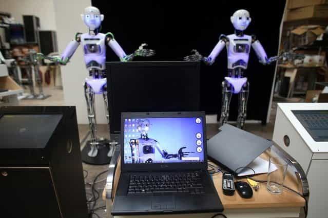 Two nearly completed RoboThespian robots inside the Engineered Arts workshop are tested on July 30, 2013 in Penryn, England. The Cornish company, operating from an industrial unit near Falmouth, is the world's only maker of commercially available life sized humanoid robots. Now in its third generation, the fully interactive and multilingual RoboThespian robot is sold around the world to science centres and visitor attractions, but increasingly to academic research groups and universities where they are used as research and development platforms. (Photo by Matt Cardy/Getty Images)