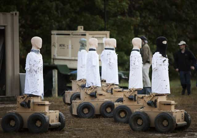 The CEOs of Marathon set and prepare Robotic Moving Targets for use in the Moving Target Technique Limited Objective Experiment 2 at Marine Corps Base Quantico, Va., September 24, 2013. The robots, developed by the Australian company Marathon, present a target the size of an average person, fall over when shot and can simulate average walking and running paces from four to eight miles an hour. The experiment tests the most effective technique and method to engage moving targets with the M-4 carbine and M-27 infantry automatic rifle. (Photo by Pfc. Eric T. Keenan/U.S. Marine Corps)