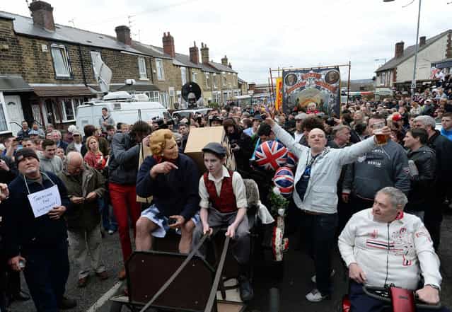 Essay Finalist – John Giles. A horse drawn hearse carrying an effigy and a coffin pass Goldthorpe Union Jack Memorial club on the day of former Prime Minister Margaret Thatchers Funeral, April 17, 2013. (Photo by John Giles/PA Wire)