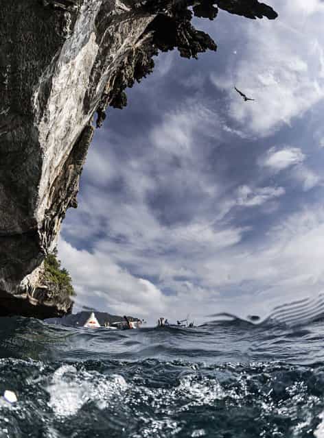 In this handout image provided by Red Bull, Alain Kohl of Luxembourg dives from a 25 metre rock at Viking Caves in the Andaman Sea during competition on the fifth day of the final stop of the 2013 Red Bull Cliff Diving World Series on October 24, 2013 at Phi Phi Island, Thailand. (Photo by Samo Vidic/Red Bull via Getty Images)