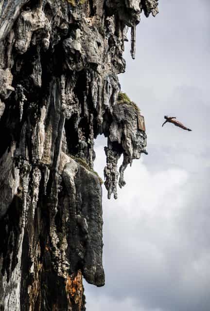 In this handout image provided by Red Bull, Orlando Duque of Colombia dives from a 25 metre rock at Viking Caves in the Andaman Sea during competition on the fifth day of the final stop of the 2013 Red Bull Cliff Diving World Series on October 24, 2013 at Phi Phi Island, Thailand. (Photo by Dean Treml/Red Bull via Getty Images)