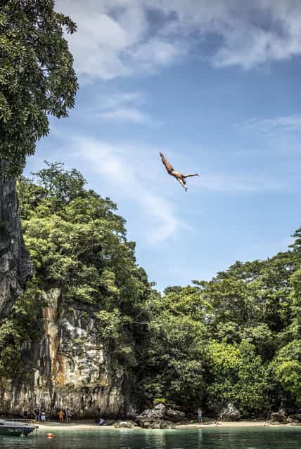 In this handout image provided by Red Bull, Artem Silchenko of Russia dives from the 27 metre platform at training on Hong Island in the Andaman Sea during the final stop of the 2013 Red Bull Cliff Diving World Series on October 25, 2013 at Krabi, Thailand. (Photo by Romina Amato/Red Bull via Getty Images)