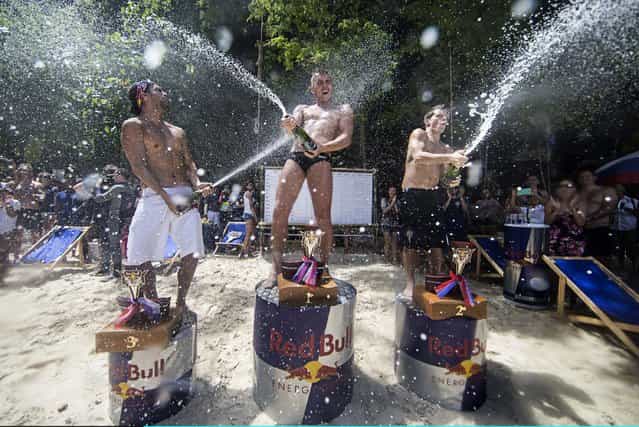 In this handout image provided by Red Bull, event and series winner Artem Silchenko (C) of Russia celebrates on the podium with 2nd placed Steven LoBue (R) of the USA and 3rd placed Orlando Duque (L) of Colombia on Hong Island in the Andaman Sea during the last competition day of the eighth and final stop of the 2013 Red Bull Cliff Diving World Series on October 26, 2013 at Krabi, Thailand. (Photo by Samo Vidic/Red Bull via Getty Images)