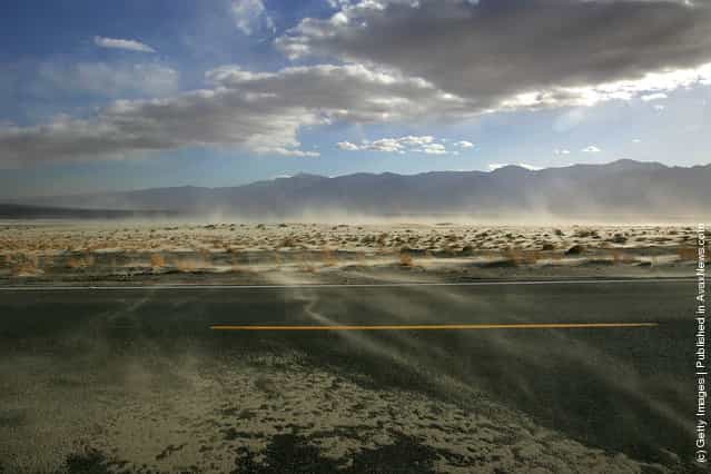 High winds blow sand across the highway near the original north shore of Owens Lake