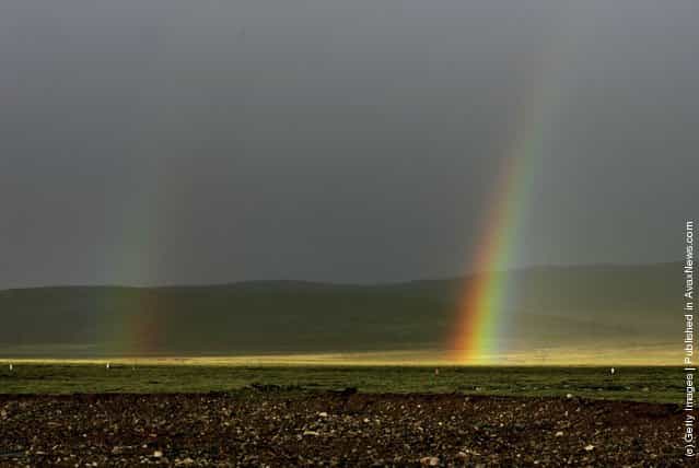 A rainbow appears at the Tanggula Mountain on June 30, 2006 in Tanggula Mountain of Qinghai Province, China