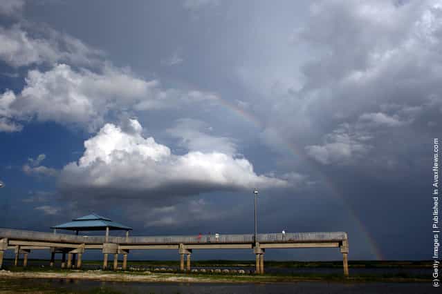 A rainbow graces the sky over a pier built over what should be lake Okeechobee in Okeechobee, Florida