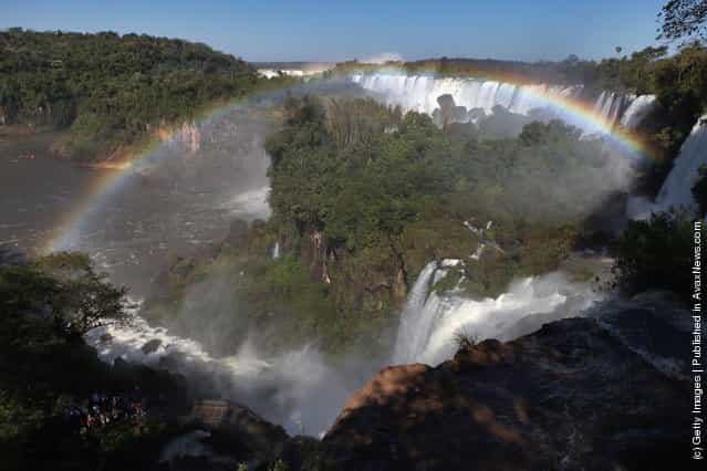 The rainbow which frames San Martin Island is formed by mist rising from the Iguacu Falls in the Iguazu National Park