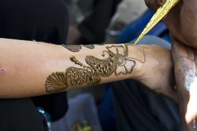 Application of henna or [Mehndi] to a girls hand in a market in Jaipur, India