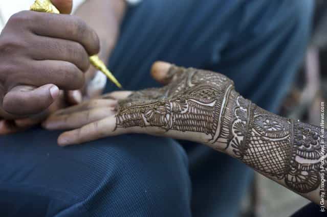 Application of henna or [Mehndi] to a girls hand in a market in Jaipur, India
