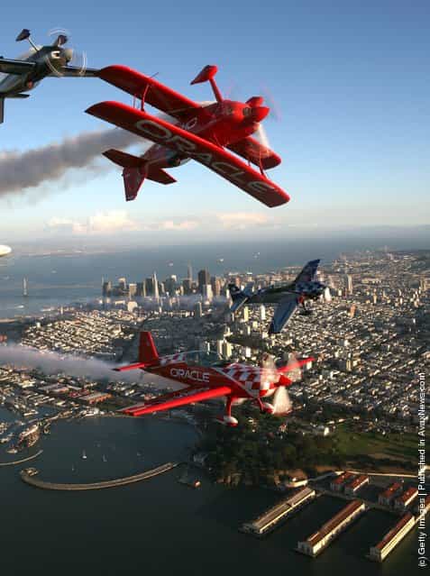 Planes for Team Oracle perform over downtown San Francisco during a practice session for San Francisco Fleet Week