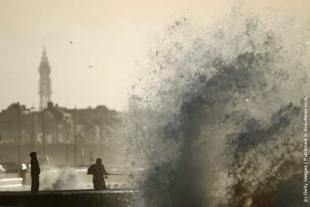 Hardy fishermen brave the wind whipped waves to fish off Blackpool promenade