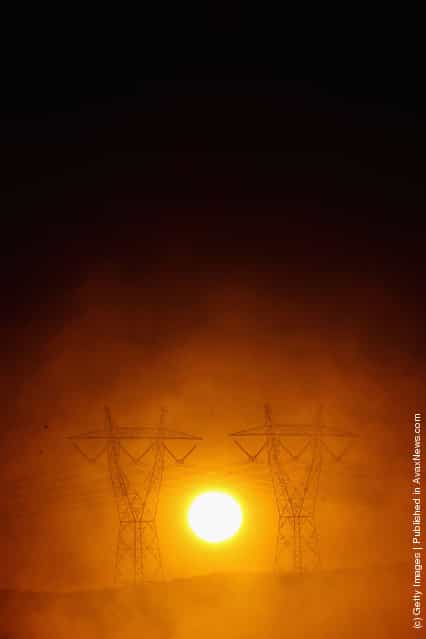 A view of power lines in early morning fog from the Hazelwood Power Station cooling pondage in Melbourne, Australia