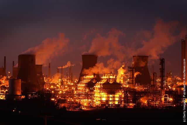 An illuminated Grangemouth Oil Refinery emits smoke in Grangemouth, Scotland