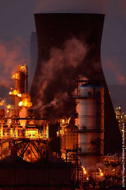 An illuminated Grangemouth Oil Refinery emits smoke in Grangemouth, Scotland