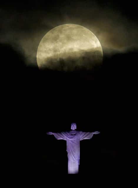 The Supermoon – the moon made its closest approach of the year to Earth – appears above the Christ the Redeemer statue in Rio de Janeiro on May 6, 2012