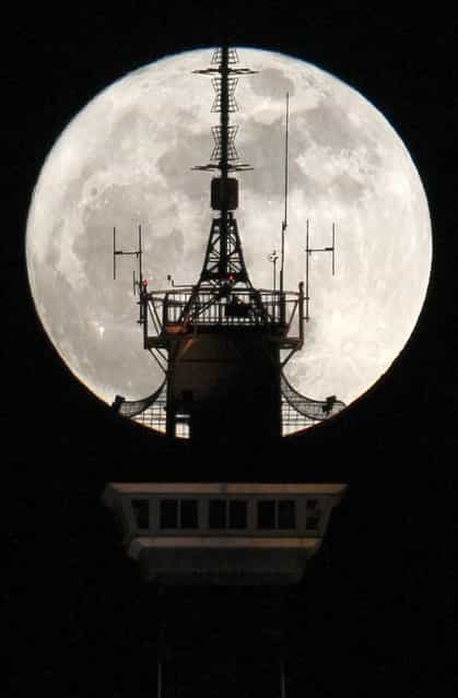 The moon is seen behind the top of the radio and television tower [Funkturm] in Berlin March 19, 2011. Saturday will see the rise of a full moon called a [Super Moon] when it arrives at its closest point to the Earth in 2011, a distance of 221,565 miles or 356,575 km away