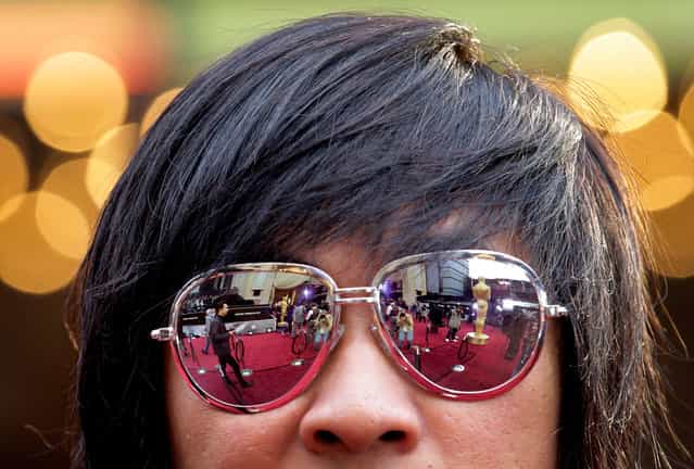 The bustling scene on the red carpet is seen reflected in the sunglasses of actor Ple Nakorn Sirachai