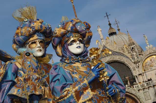 Traditionaly masked Venetians pose on San Marco square during the Carnival February 23, 2006 in Venice, Italy. (Photo by Franco Origlia)