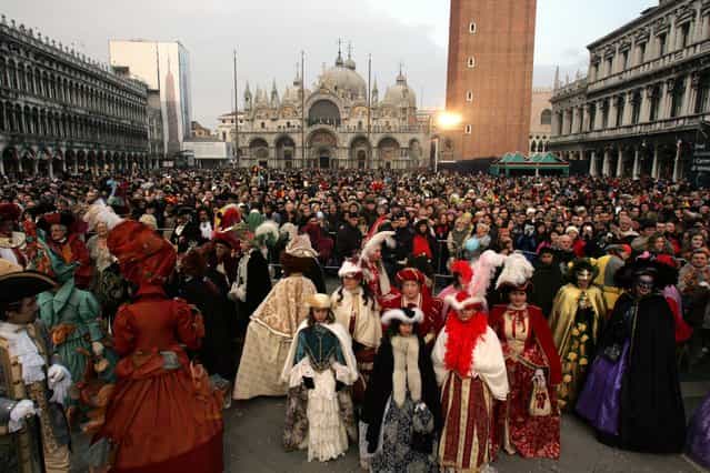Costumed Partecipants of the great historical parade stand in St.Mark's Square during the Carnival on February 18, 2006 in Venice, Italy. (Photo by Marco Di Lauro)