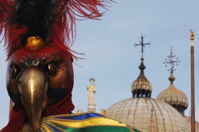A traditionaly masked Venetian pose on San Marco square during the Carnival February 23, 2006 in Venice, Italy. (Photo by Franco Origlia)
