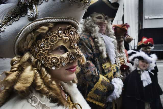 Masked participants stand in St.Mark's Square during the Carnival on February 11, 2007 in Venice, Italy. (Photo by Marco Di Lauro)