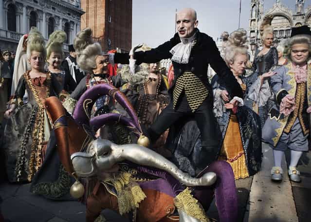Masked dwarfs and people perform in St.Mark's Square, during the flight of the angel as a traditional opening ceremony for the beginning of the Carnival, on February 11, 2007 in Venice, Italy. (Photo by Marco Di Lauro)
