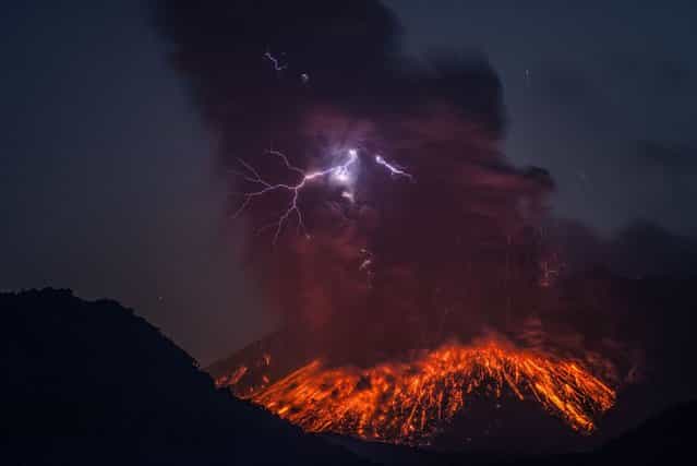 Lightning can be seen emerging through the lava eruption. Images were captured on February, 24 2013, around 4.50am, 3-4km east of the volcano in the Kaghoshima area of South Japan. (Photo by Martin Rietze/Guzelian)
