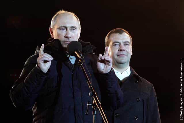 Russian Prime Minister and presidential candidate Vladimir Putin speaks as current President Dmitry Medvedev (R) listens during a rally after Putin claimed victory in the presidential election at the Manezhnya Square March, 4, 2012 in Moscow, Russia