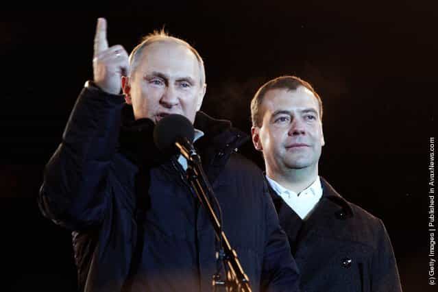 Russian Prime Minister and presidential candidate Vladimir Putin speaks as current President Dmitry Medvedev (R) listens during a rally after Putin claimed victory in the presidential election at the Manezhnya Square March, 4, 2012 in Moscow, Russia