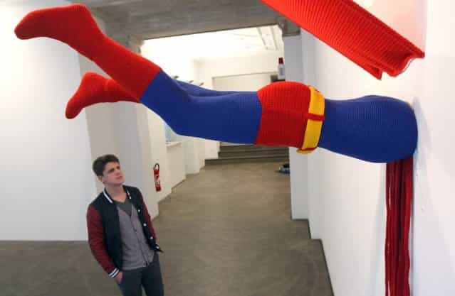 The knitted sculpture Superman by Patricia Waller, featuring the comic book character meeting death by his own superhuman ability to fly, hangs in the Broken Heroes exhibition at the Deschler Gallery