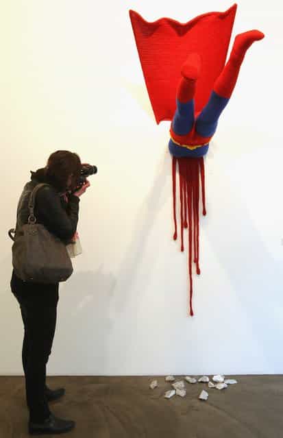The knitted sculpture Superman by Patricia Waller, featuring the comic book character meeting death by his own superhuman ability to fly, hangs in the Broken Heroes exhibition at the Deschler Gallery
