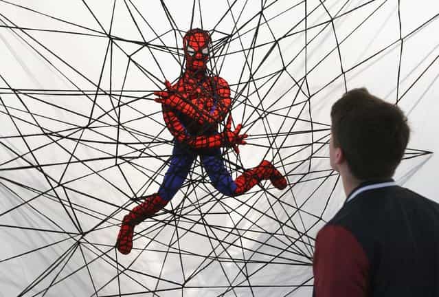 The knitted sculpture Spiderman by Patricia Waller, featuring the comic book character as an imprisoned victim of his own web, hangs in the Broken Heroes exhibition at the Deschler Gallery