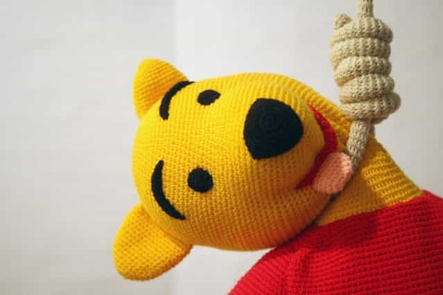 The knitted sculpture Winnie Pooh by Patricia Waller, featuring the childrens book character as a suicide victim, hangs in the Broken Heroes exhibition at the Deschler Gallery