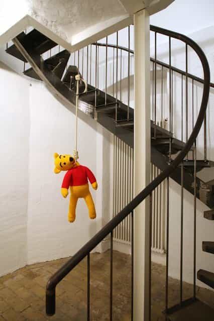 The knitted sculpture Winnie Pooh by Patricia Waller, featuring the childrens book character as a suicide victim, hangs in the Broken Heroes exhibition at the Deschler Gallery