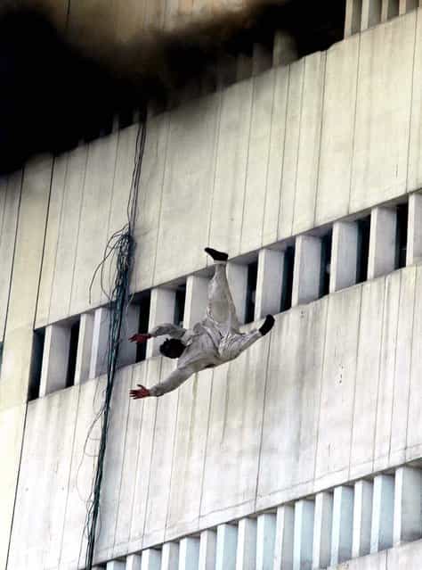 The man falls from the fifth floor of the 13-story building. (Photo by K.M. Chaudary/Associated Press)