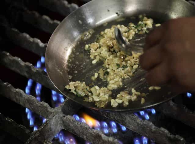 Mexican chef Alejandro Pinon fries ant eggs at the Corazon de Maguey restaurant in Mexico City June 18, 2013. (Photo by Henry Romero/Reuters)