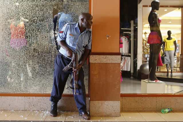 A police officer tries to secure an area inside the Westgate Shopping Centre. (Photo by Siegfried Modola/Reuters)