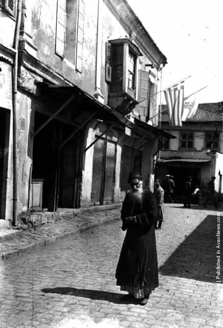 circa 1917: A bearded Jewish man stands in a cobbled street in Palestine