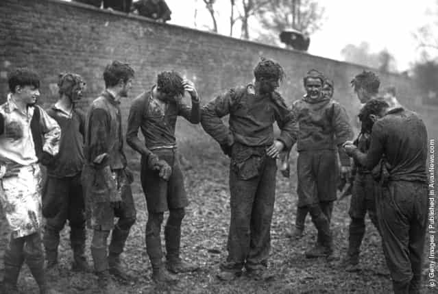 1939: Eton school boys covered in mud after taking part in the annual Wall Game