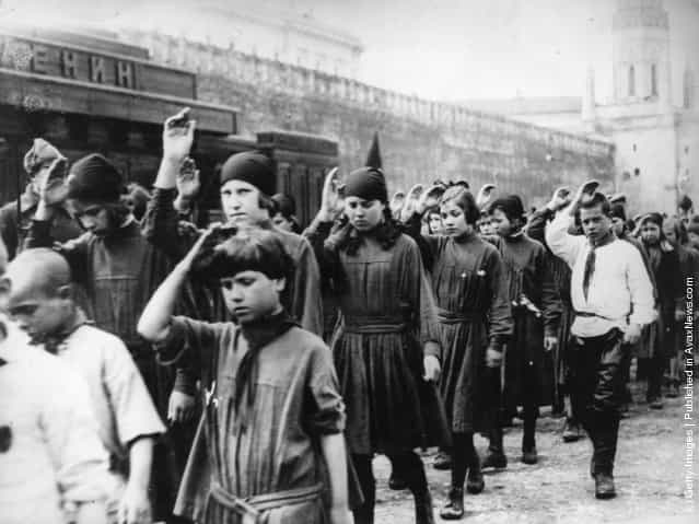 1924: Young Communists saluting as they pass Lenins Tomb on May Day