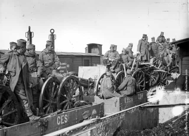 1915: Serbian soldiers and artillery in railway trucks bound for the frontier