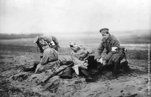 1915: Red Cross personnel attending to wounded soldiers on a Russian battlefield during the First World War