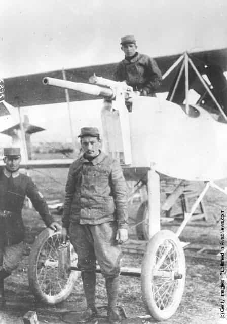 1915: Greek airmen stand with a Voisin plane, armed with a cannon