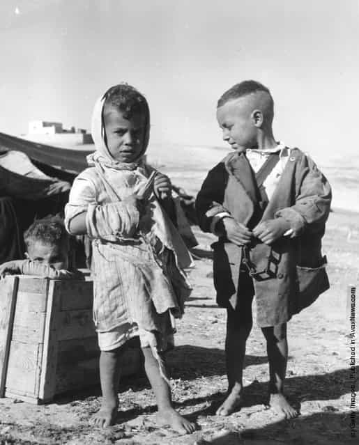 1955: Young Bedouin boys barefoot in the desert
