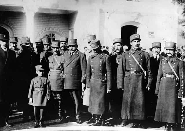 Crown Prince Valiaha of Persia who when older became the Shah of Iran is viewed with a group of officials after he officially opened a new military school in Tehran