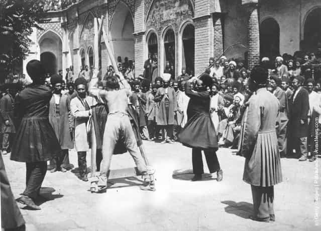 1910: A criminal is publicly whipped in the street in Persia