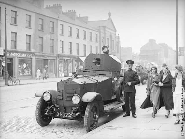 1935: A British Army Rolls Royce armoured car outside the Royal Ulster Constabulary police station on York Street in Belfast following riots after an Orange Order parade